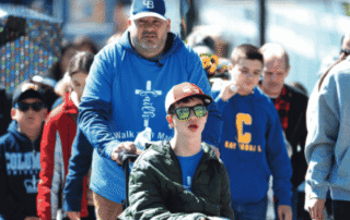 Cover of Magazine with boy in wheelchair being pushed by dad